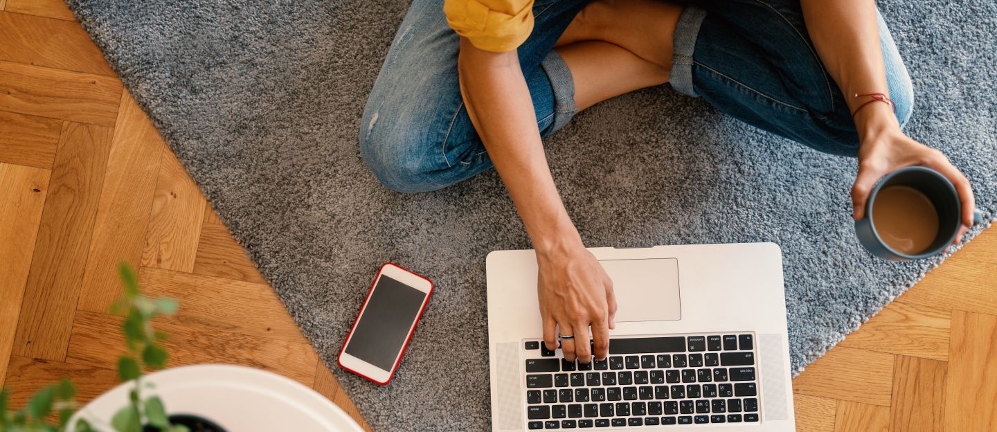 Woman,In,A,Yellow,Shirt,Works,On,A,Laptop,With